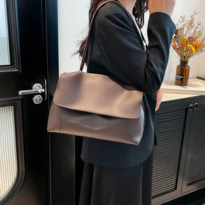 Minimalist large brown PU leather tote bag shown on model for elegant office commuting style