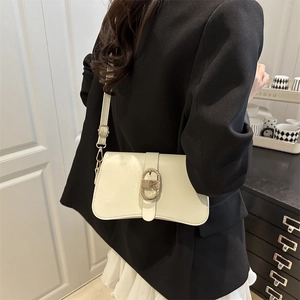 Chic cream leather baguette shoulder bag with gold oval buckle and adjustable strap