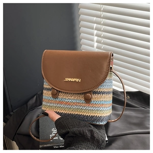 Close-up of rainbow straw weave texture and brown leather flap with gold logo