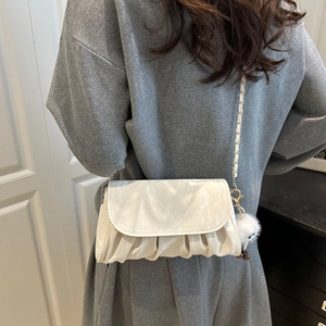 Chic beige pleated cloud bag with chain strap and plush ball charm for women