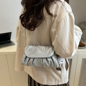 Chic ruched cloud crossbody bag for women with silver chain strap and plush charm