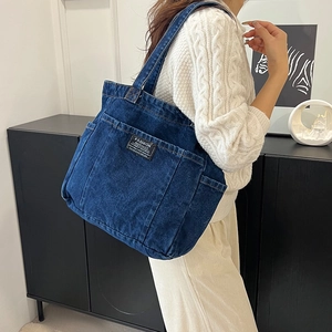 Vintage blue washed denim canvas tote bag with multi-pocket design and large capacity