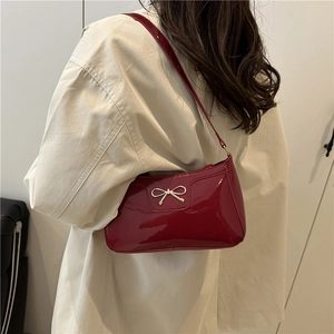 Fashionable red patent leather underarm bag with gold bow decoration for women