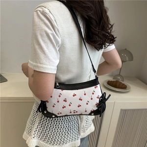 Summer trendy shoulder bag with red cherry prints and black bow detail on the side