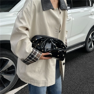 Glossy black pleated clutch bag with golden mushroom studs and metallic frame closure