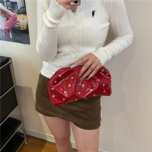 Fashionable red patent leather pleated clutch bag with golden metal mushroom rivets decoration