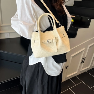 Chic cream woven texture handbag with silver metal eyelets and a versatile shoulder strap