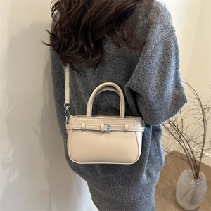 Chic beige minimalist crossbody square bag with top handle and decorative strap detail