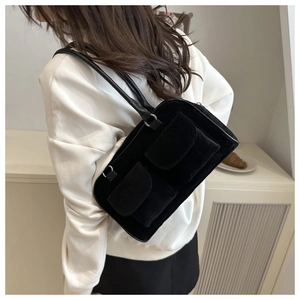 Chic black faux suede shoulder bag with dual functional pockets shown on model