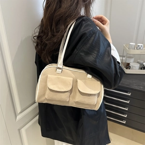 Minimalist canvas shoulder bag with dual front utility pockets in beige and white