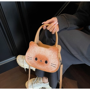 Detail view of the toast brown cat shaped handbag with adjustable crossbody strap
