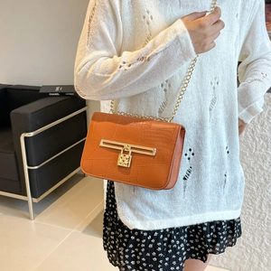 Fashionable orange crocodile textured crossbody bag with gold heart lock and chain strap
