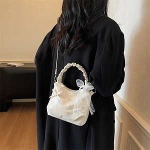 Creamy white scrunchie handle handbag with lace bow detail and crossbody strap