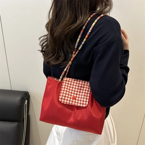 Retro red crossbody bag with checkered flap and colorful woven shoulder strap for women