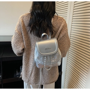 Detail of silver metallic backpack with cute cat illustrations and adjustable straps
