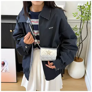 Silver quilted mini chain bag with star detail styled with casual autumn fashion