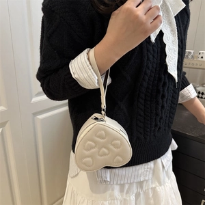 Mini cream heart-shaped crossbody bag with chic quilted stitching and silver zipper