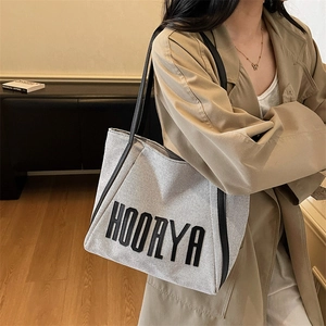 High-capacity light gray canvas tote bag with black HOORYA embroidery for daily casual use