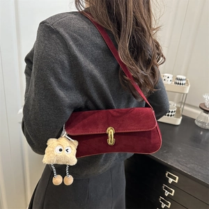 Chic burgundy suede underarm bag with gold clasp and plush star charm for women