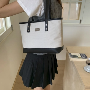 Chic beige woven tote bag with black leather trim and handles for stylish women's daily commute