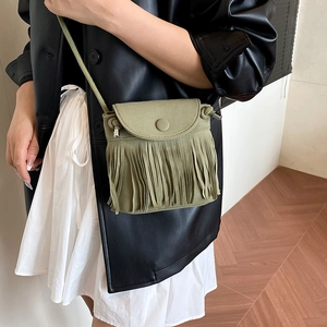 Green bohemian tassel crossbody bag with vintage fringe style for women in minimalist setting