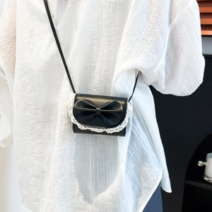 Mini black PU leather crossbody bag with white lace trim and large bow decoration