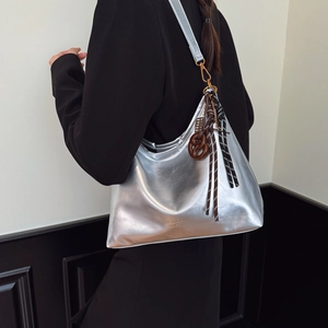 Metallic silver hobo shoulder bag with fashion bags print and woven decorative charms