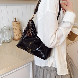 Elegant black glossy leather shoulder bag with striped woven strap and gold details