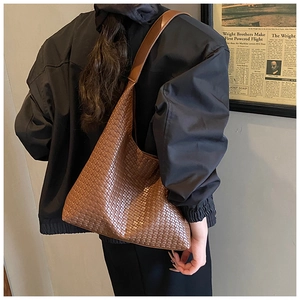 Close-up of caramel brown woven texture on a large hobo tote bag for daily commute