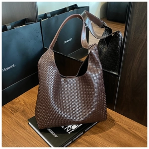 Detailed close-up of dark brown woven texture on premium large capacity tote bag