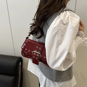 Chic dark red patent leather shoulder bag with silver studs and buckle strap detail