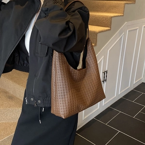 Brown woven leather hobo tote bag for women showing large capacity and minimalist design