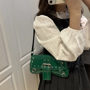 Deep green glossy underarm bag with silver rivets and metal buckle in Y2K style