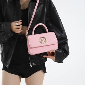 Pink patent leather crossbody handbag for women with gold M logo and slim strap