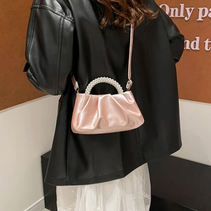 Pink satin pleated dumpling bag with pearl handle and crossbody strap for elegant women