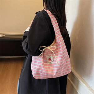 Pink and blue plaid canvas shoulder bag with a handmade logo tag and bow decoration