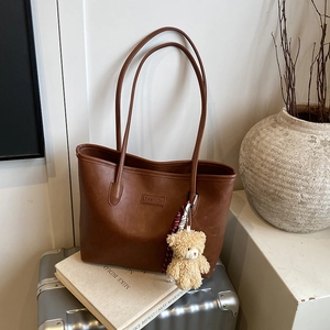 Retro brown PU leather tote bag with a fashion tag and a cute plush bear pendant