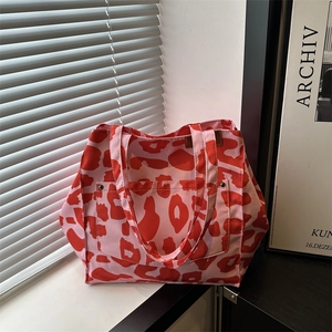 Pink canvas tote bag with bold red leopard print for daily commute and work