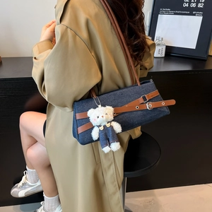 Retro denim underarm bag with brown leather straps and a cute teddy bear charm