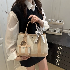 Chic beige canvas tote bag for women with decorative scarf and mini pouch on mannequin