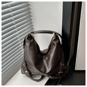 Detailed close-up of dark brown PU leather texture and gold hardware on a retro tote bag