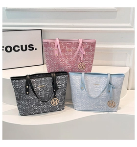 Three checkered tote bags in pink, black, and blue with gold M charms and rivet details