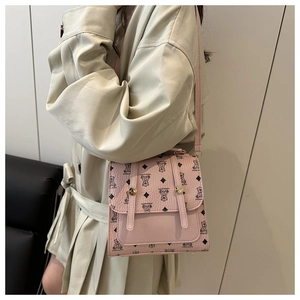 Detail showing pink PU leather crossbody bag with cute bear print and metal buckles