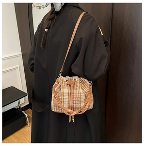 Dettagli della borsa a secchiello vintage in lana a quadri con coulisse e tracolla in pelle