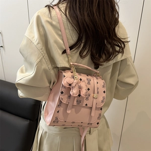 Pink faux leather backpack with teddy bear pattern and metal chain charm for women