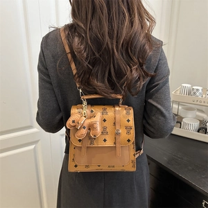 Classic brown polka dot mini backpack for women featuring cute bear patterns and dog charm