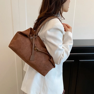 Vintage brown suede tote bag with slim shoulder straps and minimalist retro design