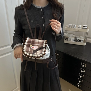 Sweet mini backpack with brown plaid flap, ruffle trim, and star print patterns
