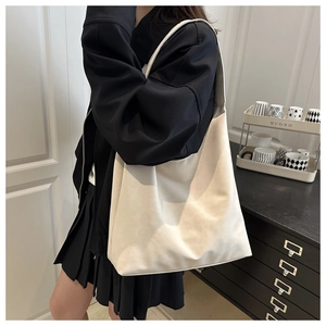 Close-up of a cream white oversized tote bag made of matte soft leather for daily commute