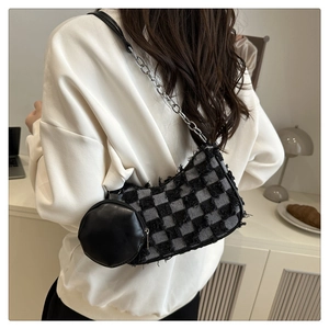 Detail of checkered tweed hobo bag featuring frayed edges and detachable round coin purse
